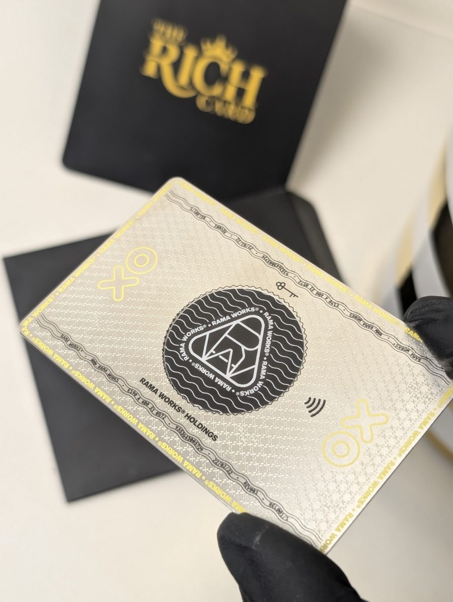 RAMA WORKS metal card with detailed patterned artwork and gold-tone accents